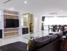 Modern living room with built-in TV unit and dining area