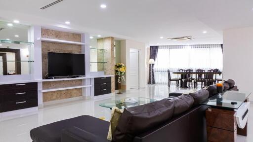 Modern living room with built-in TV unit and dining area