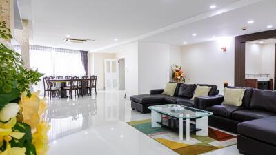 Modern living room with dining area in the background