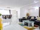 Modern living room with dining area in the background