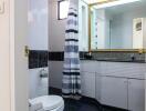 Bathroom with striped shower curtain and large mirror