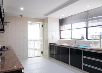 Modern kitchen with appliances and ample natural light