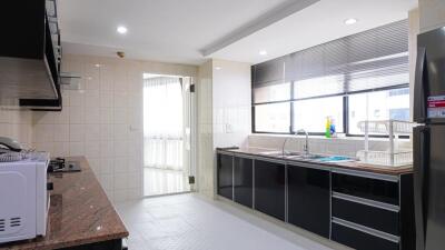 Modern kitchen with appliances and ample natural light