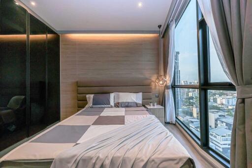 Modern bedroom with large window and city view