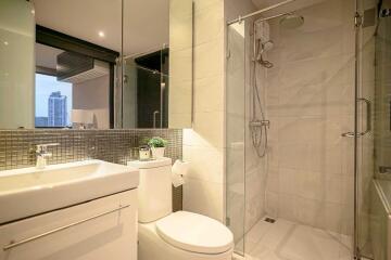 Modern bathroom with glass shower and large mirror