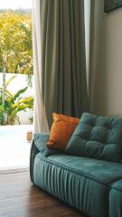 Living room with sofa and view of garden through large window