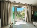 Bright living room with large glass sliding doors and a view of greenery outside