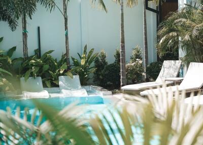 Outdoor patio with pool and lounge chairs