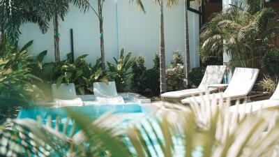 Outdoor patio with pool and lounge chairs