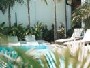 Outdoor patio with pool and lounge chairs