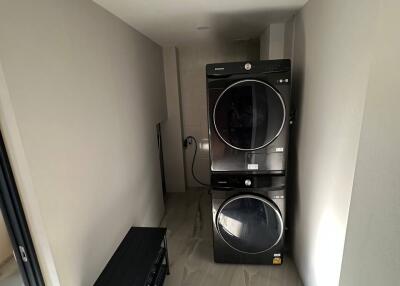 Modern laundry room with stacked washer and dryer