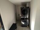 Modern laundry room with stacked washer and dryer