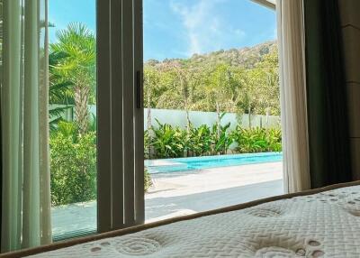 View from bedroom with sliding glass doors leading to outdoor area