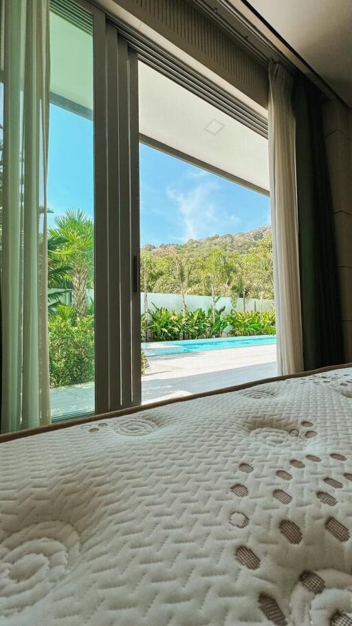 View from bedroom with sliding glass doors leading to outdoor area