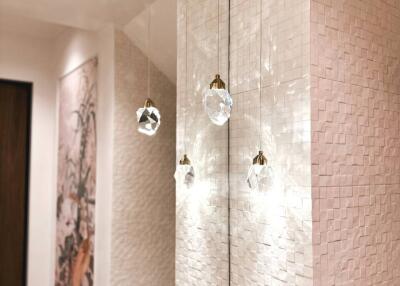Modern hallway with stylish lighting fixtures and textured walls