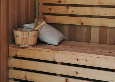 wooden sauna with bench and accessories
