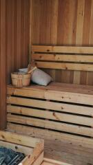 wooden sauna with bench and accessories