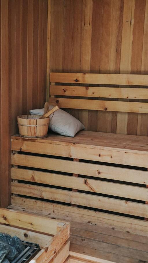 wooden sauna with bench and accessories