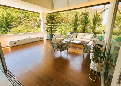 Patio with outdoor furniture and lush greenery