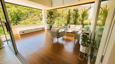 Patio with outdoor furniture and lush greenery