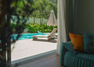 Living room with sofa and view of outdoor pool