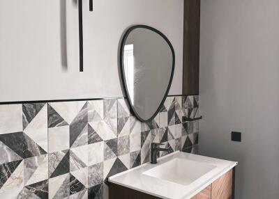 Modern bathroom with geometric tile design