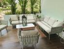 A cozy balcony with seating area and greenery