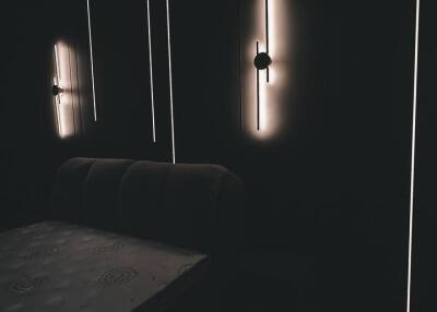 Dimly lit bedroom with modern wall lights