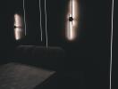 Dimly lit bedroom with modern wall lights