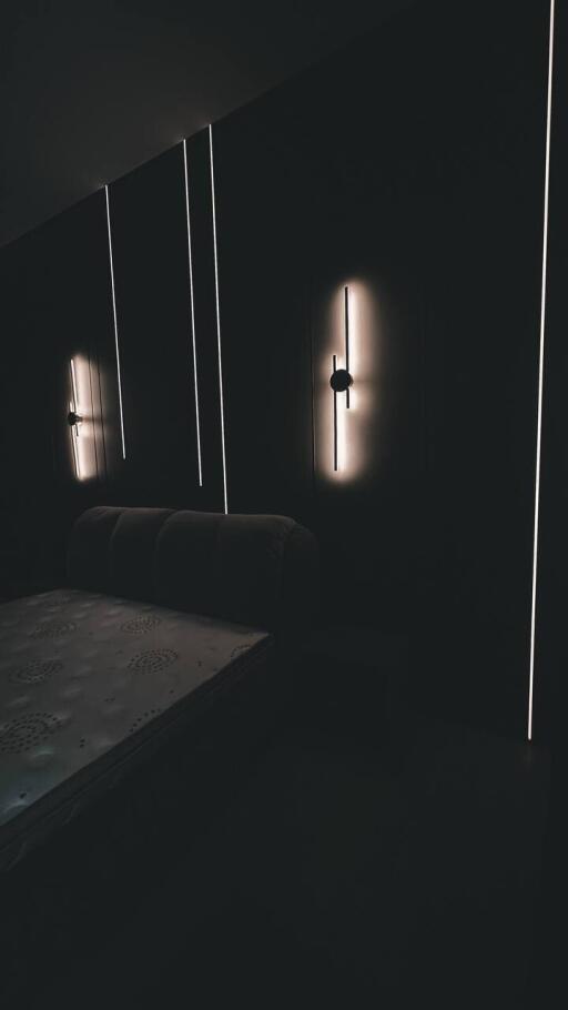 Dimly lit bedroom with modern wall lights