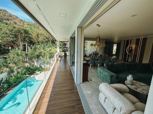 Spacious living area with open layout, pool view, and adjacent balcony