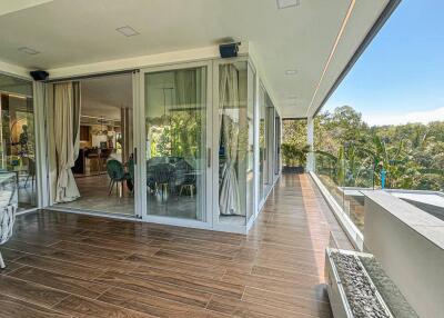 Spacious balcony with modern furniture and large glass doors