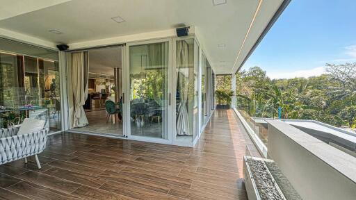 Spacious balcony with modern furniture and large glass doors