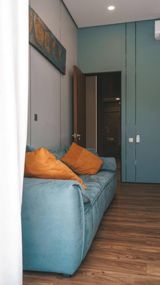 Cozy living room with blue sofa and orange cushions