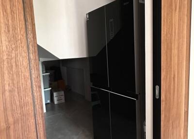 View of a kitchen with a modern refrigerator