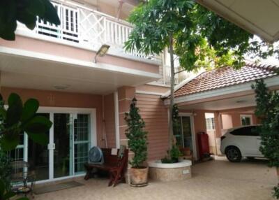 Front view of a house with a carport and balcony