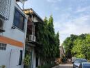 Street view of residential buildings with parked cars