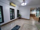 Spacious living room with tiled flooring and modern lighting