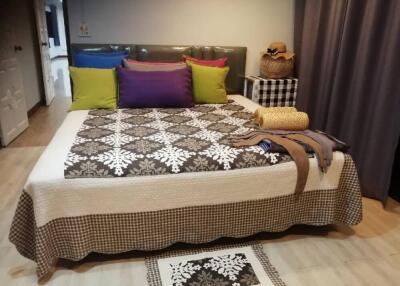 Bedroom with bed and colorful pillows