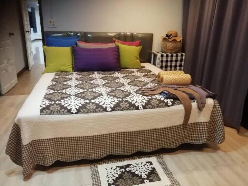 Bedroom with bed and colorful pillows