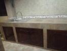 Tiled kitchen with sink and cabinets