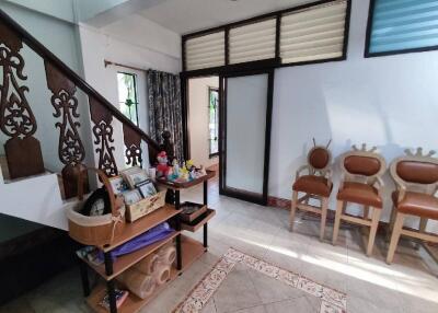 Living room with decorative wooden stairs and seating area