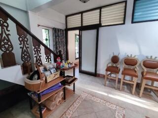 Living room with decorative wooden stairs and seating area