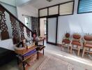 Living room with decorative wooden stairs and seating area