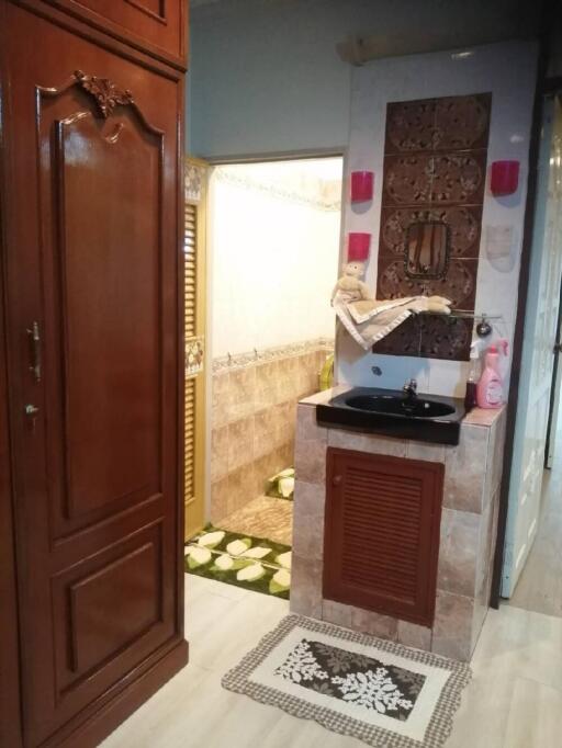 A well-maintained bathroom with wooden cabinets and decorative tiles