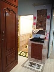 Bathroom with black sink and decorative wooden cabinetry