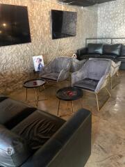 Living room with modern furniture and wall-mounted televisions