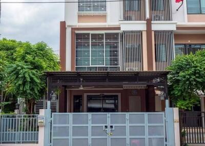 Modern two-story residential building with gated entrance