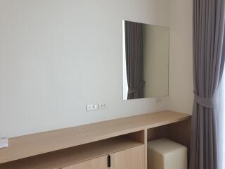 Bedroom with mirror and wooden furniture