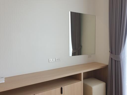 Bedroom with mirror and wooden furniture